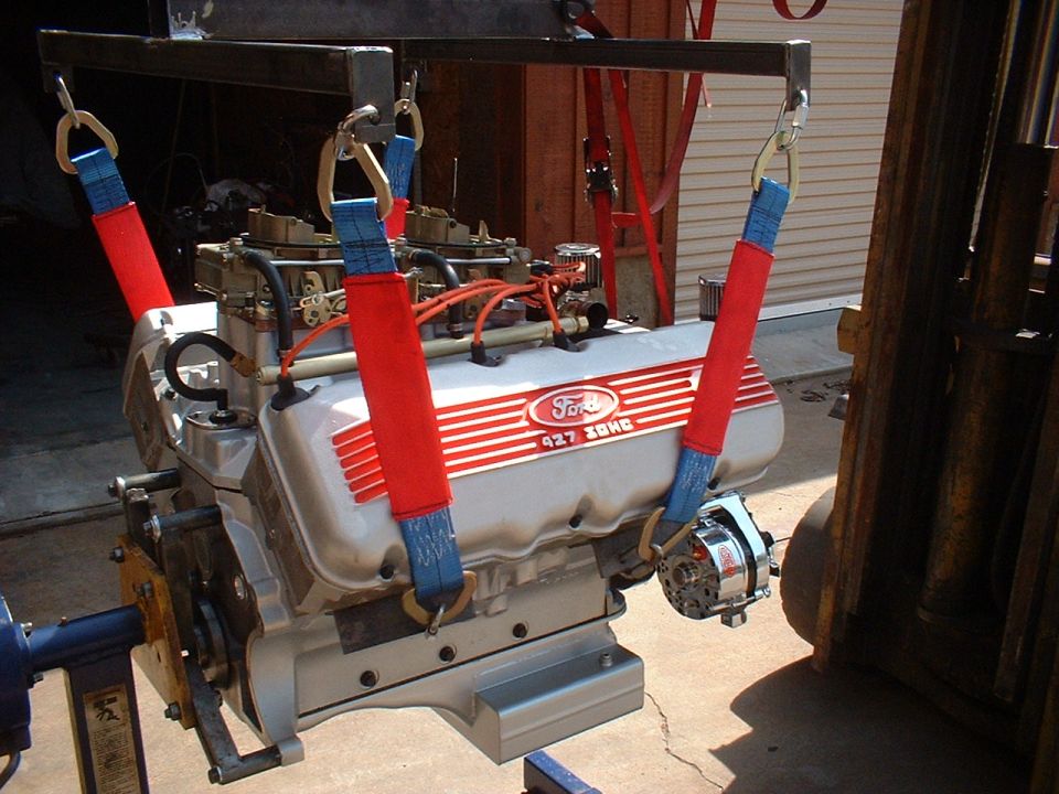 Ford 427 SOHC engine with dual carburetors, suspended by straps