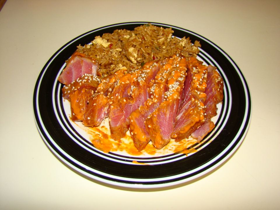 Plate of sliced tuna with rice and sesame seeds