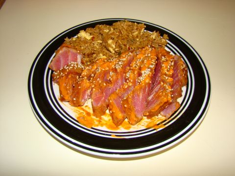 1989 Ford Bronco - A plate of sliced tuna with rice, garnished with sesame seeds and sauce.