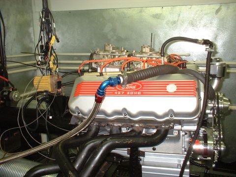 1970 Ford Mustang - A Ford 427 SOHC engine is shown on a test stand, dual carburetors and custom exhaust headers.