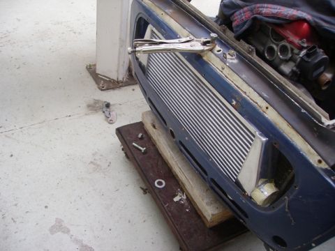 1969 MINI Cooper - Intercooler assembly secured with vice grips during a vehicle repair or restoration project.