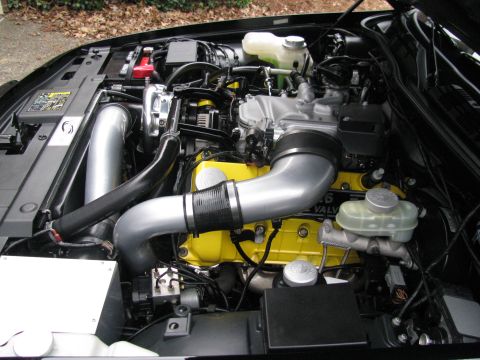 2003 Mercury Marauder - Customized engine bay a turbocharger setup and yellow valve covers with visible engine specifications.
