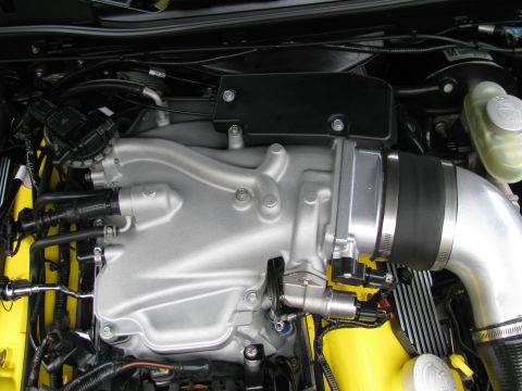 2003 Mercury Marauder - Close-up view of an engine bay, highlighting a silver intake manifold and yellow components.