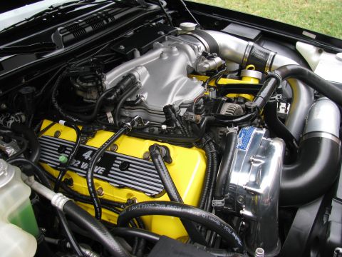 2003 Mercury Marauder - Close-up of an engine bay yellow valve covers and custom intake components.