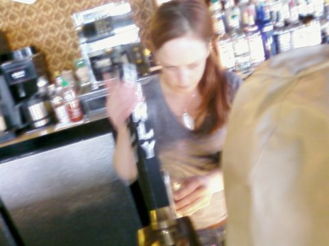 1985 Ford LTD Crown Victoria - Bartender at work behind the bar, preparing a beverage.