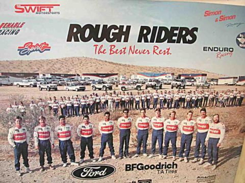 1994 Ford Bronco - A large team poses with their support vehicles and trucks at a desert racing event.