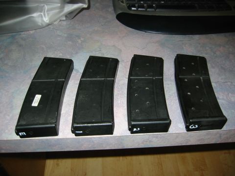 1996 Ford Bronco - Four rifle magazines are laid out on a counter next to a keyboard.