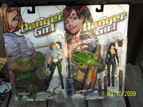 1991 Ford Bronco - Two Danger Girl action figures, Abbey Chase and Sydney Savage, are displayed in their original packaging.