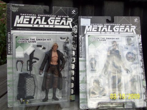 1991 Ford Bronco - Two collectible action figures from the Metal Gear Solid video game are displayed in their original packaging.