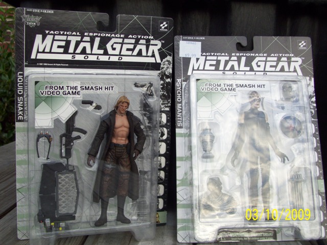 Two Metal Gear Solid action figures in plastic packaging, one labeled Liquid Snake, the other Psycho Mantis