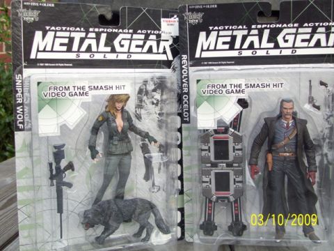 1991 Ford Bronco - Two collectible action figures from the Metal Gear Solid video game series are displayed in their original packaging.