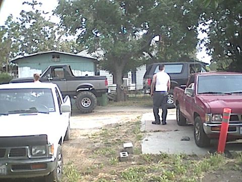 1987 Ford Bronco - A gray 1987 Ford Bronco is parked in a yard with other vehicles.