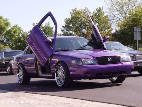1993 Ford Crown Victoria - A custom purple sedan with its doors open, parked on a street.