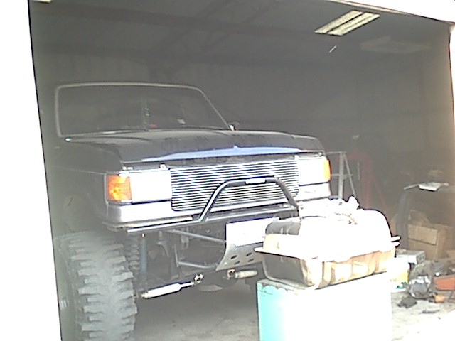 Black 1987 Ford Bronco front view with custom grille guard and large tires
