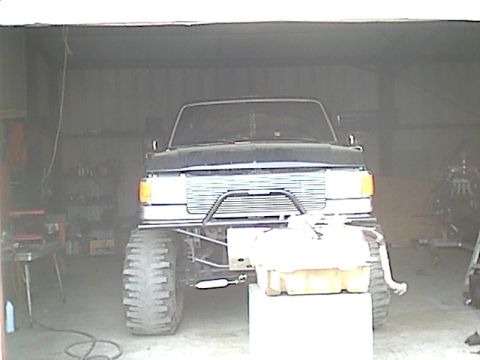 1987 Ford Bronco - Front view of a lifted 1987 Ford Bronco with aftermarket bumper and large tires.