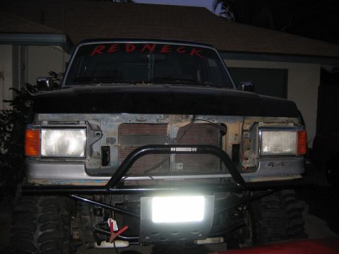 1987 Ford Bronco - This truck has a custom brush guard and a prominent light bar mounted on the front bumper.