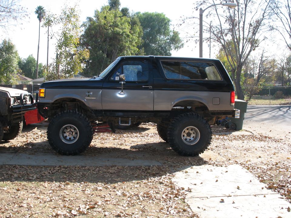 Lifted 1987 Ford Bronco, two-tone gray and black, side view