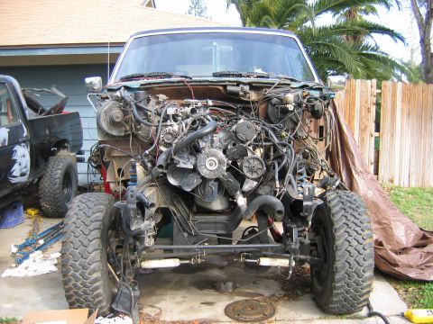 1987 Ford Bronco - Front view of a 1987 Ford Bronco undergoing disassembly, revealing its engine and chassis.