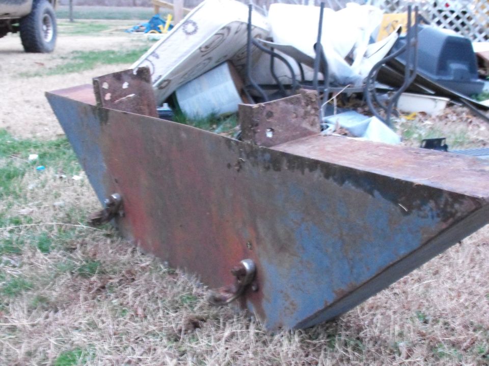 Rusted metal bumper part with blue and red paint remnants