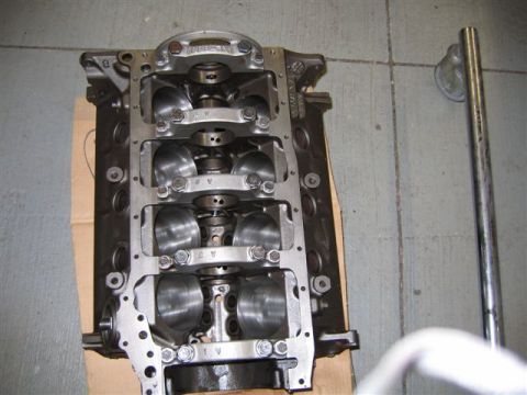 1972 Ford Ranchero - Close-up view of an engine block, showing the internal crankshaft and bearing caps. The part is on a workshop floor.