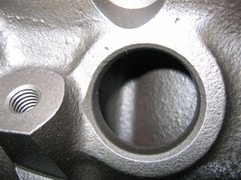 1972 Ford Ranchero - This image shows a detailed view of a cast iron engine component, a threaded opening and a larger bore.