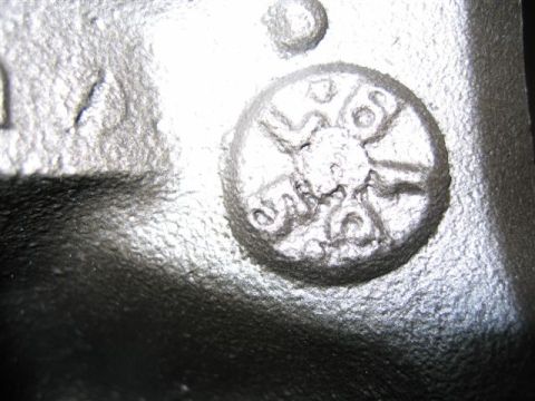 1972 Ford Ranchero - Cast metal part shows circular embossed markings, possibly a component identifier.