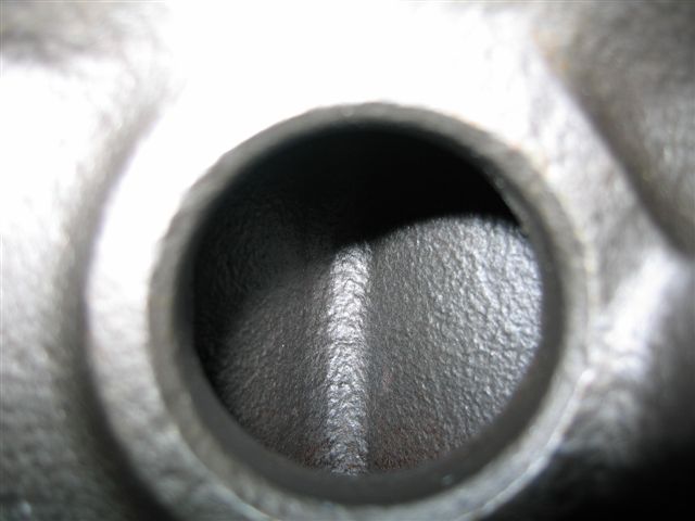 Close-up of an engine cylinder head port, showing the intake or exhaust passage