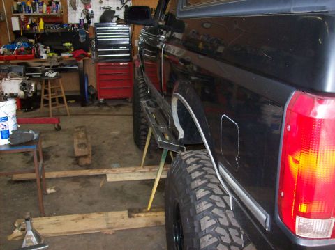 1992 Ford Bronco - Side view of a 1992 Ford Bronco with custom running boards and off-road tires.