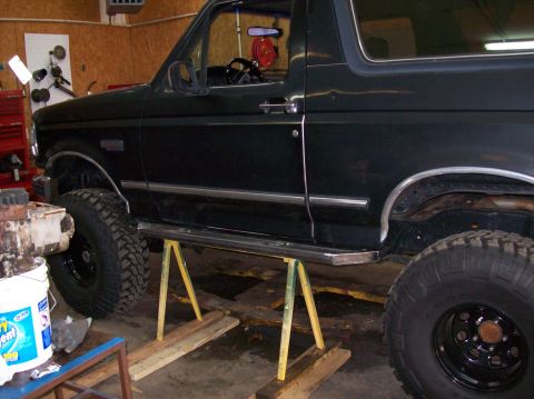 1992 Ford Bronco - This 1992 Ford Bronco is elevated on jack stands, revealing its undercarriage and large off-road tires.