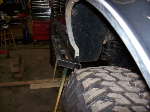 1992 Ford Bronco - Installing aftermarket sliders on a 1992 Ford Bronco in a garage setting.