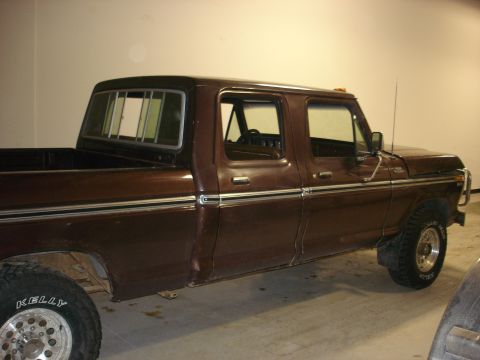 1979 Ford F-250 - Side view of a brown four-door pickup truck parked indoors.