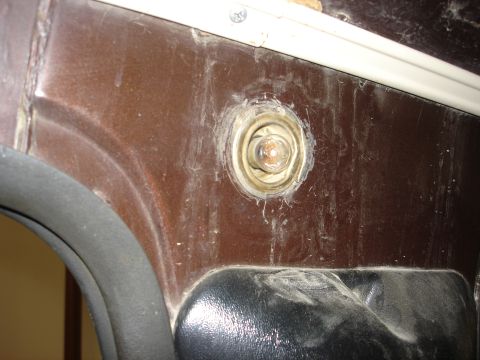 1979 Ford F-250 - A close-up shot of the interior door panel reveals a circular fixture and dark trim, showing wear and tear.