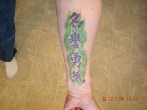 1974 Ford Ranchero - A close-up shows a tattoo with Japanese characters on a person's arm, with a date stamp in the corner.