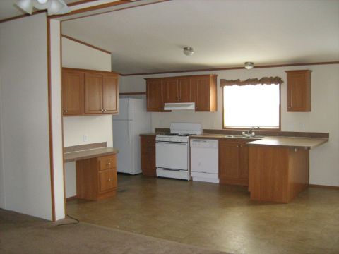 1988 Mercury Grand Marquis - Interior view of a kitchen wood cabinetry, a refrigerator, stove, dishwasher, and a built-in desk area.