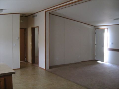 1988 Mercury Grand Marquis - The interior of a house is shown, with multiple doorways and carpeted floors.