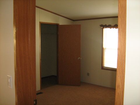 1988 Mercury Grand Marquis - Interior view of a room with carpet and wood paneling.