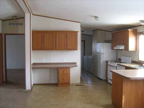 1988 Mercury Grand Marquis - Interior view of a house, showing a kitchen with appliances and cabinetry, as well as a laundry area.
