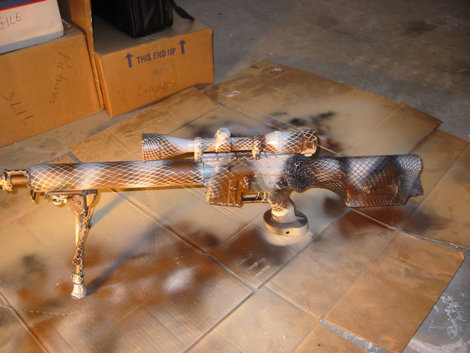 Sniper rifle with camouflage paint job and bipod