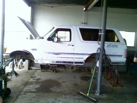 1996 Ford Bronco - This 1996 Ford Bronco is undergoing maintenance, lifted on jack stands with its hood open.