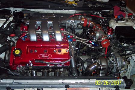 1994 Ford Probe - Engine bay view of a modified Ford engine a turbocharger and custom plumbing.