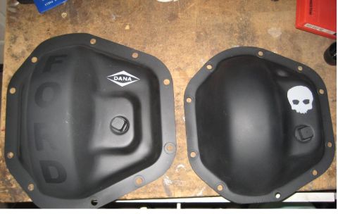 1996 Ford Bronco - Two aftermarket differential covers are shown, one branded DANA and the other decorated with a skull graphic.