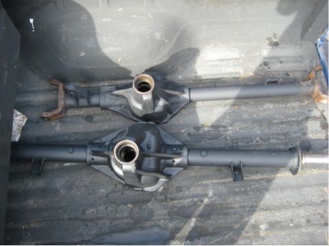 1996 Ford Bronco - Two differential axles are shown in a truck bed, with visible text from Supermotors.net.