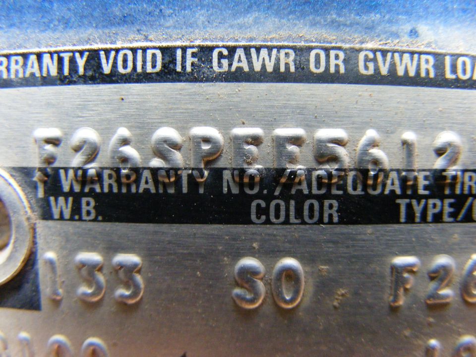Close-up of embossed Ford warranty plate serial and W.B. 133, color SO fields