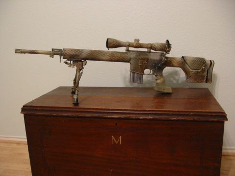 1996 Ford Bronco - A sniper rifle with a camouflage pattern is displayed on a wooden chest.