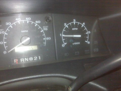 1995 Ford Bronco - The image shows a close-up of a vehicle's dashboard, featuring a speedometer, tachometer, and gear indicator. The speedometer reads approxi…