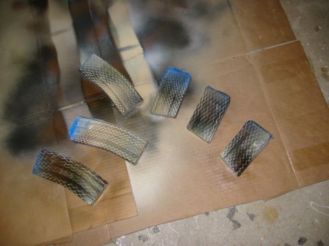 1996 Ford Bronco - Several clear plastic rectangular objects with a diamond pattern are laid out on a piece of cardboard. Some of the objects have blue tape o…