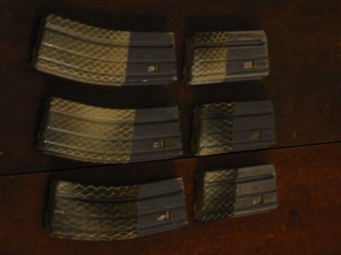 1996 Ford Bronco - The image shows six rifle magazines arranged in three rows of two on a dark wooden surface. The magazines have a textured grip area on the…