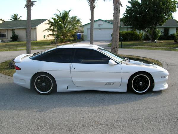 White 1994 Ford Probe GT with black hood and wheels, side view.