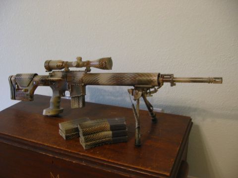 1996 Ford Bronco - A camouflage-patterned rifle with a scope and bipod rests on a wooden surface next to two magazines.