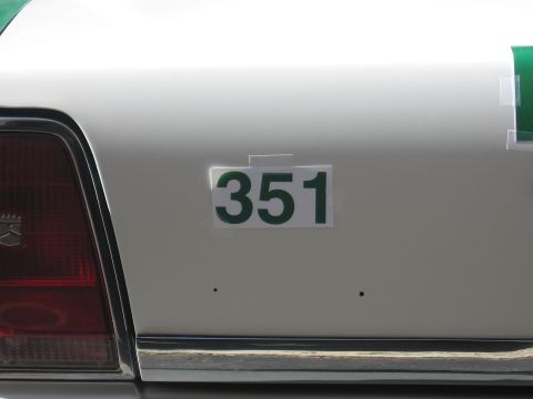 1991 Ford LTD Crown Victoria - Close-up of a green 351 decal applied to the white rear quarter panel of a sedan next to a red taillight.